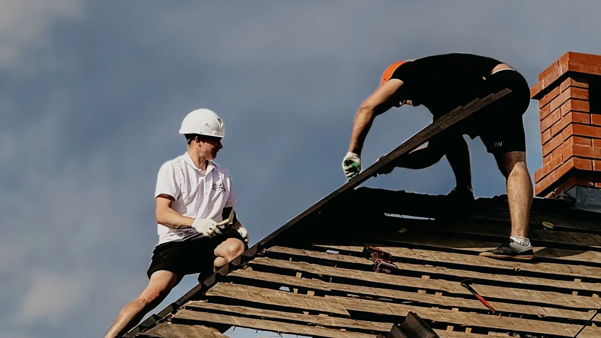 Roofing contractors replacing a roof, the kind of local business SEO for roofers helps win more jobs